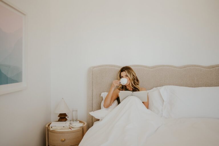 woman drinking coffee in bed