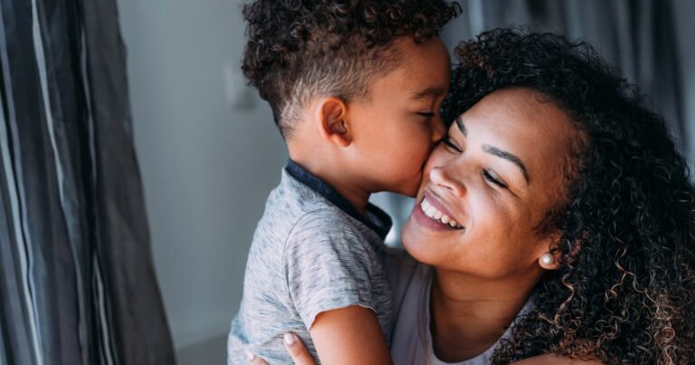 lovely mother embracing kissing