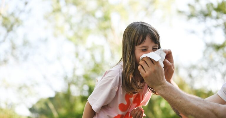 preschool girl sneezing in