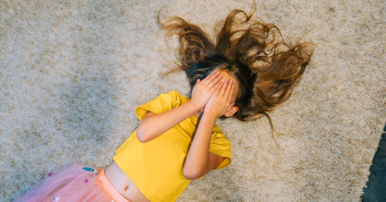 young girl lies on